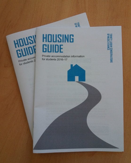 Two copies of the housing guide on a table