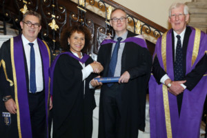 Chi-chi Nwanoku OBE (middle left), presenting an award to Mark Pemberton with Dr Anthony Bowne, Principal of Trinity Laban (left) and Dr Geoffrey Copeland CBE, Vice Chair of Trinity Laban, (right).