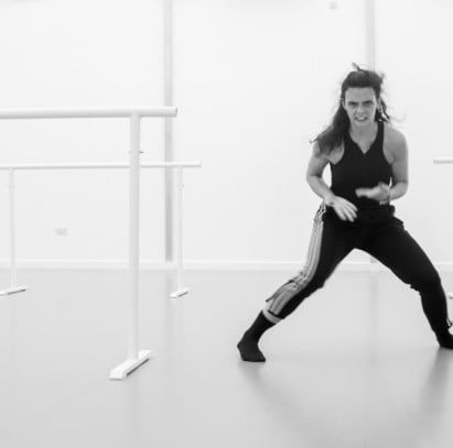 A dancer moving with an intense look on her face