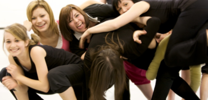 Pile of young dancers connected in a dance studio