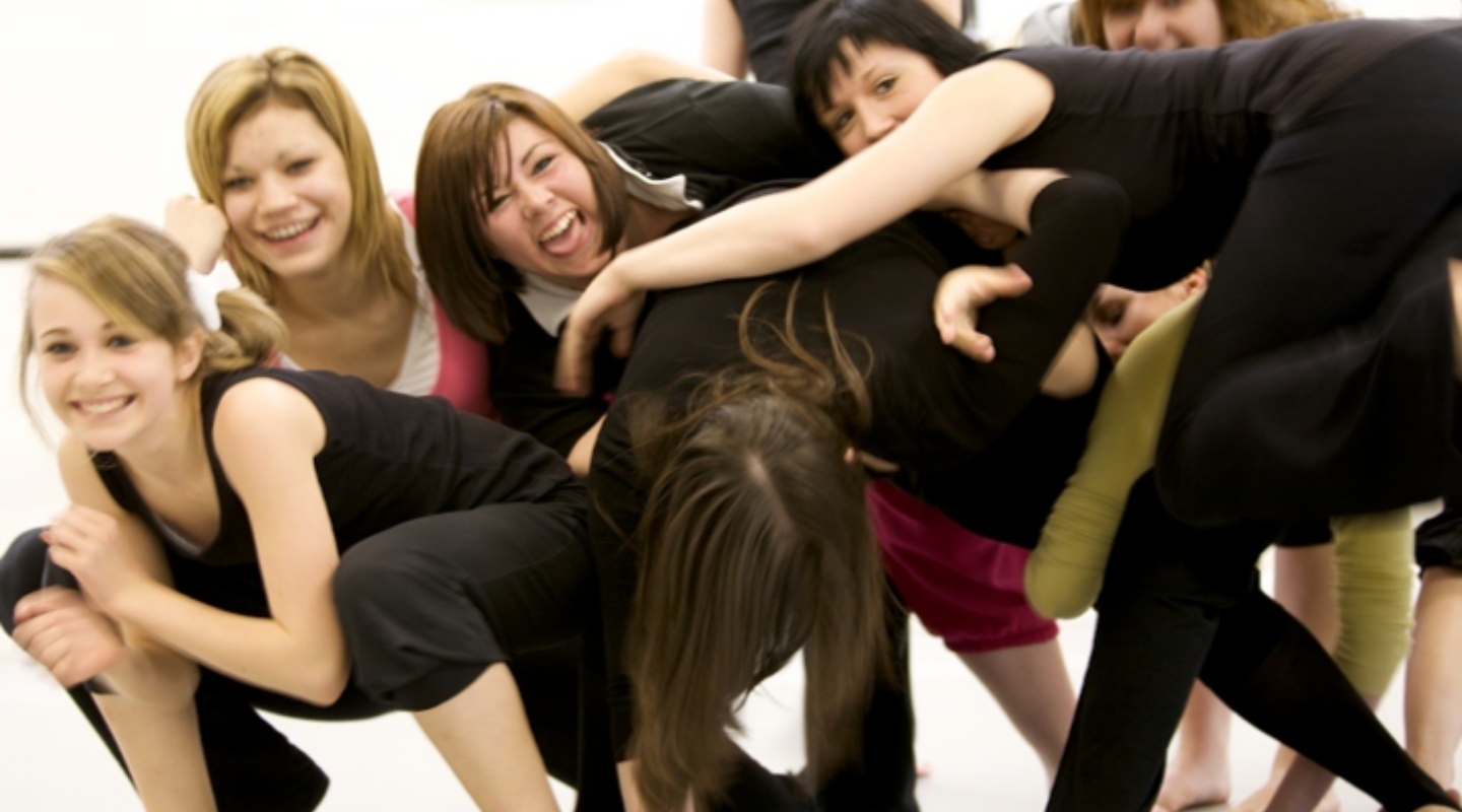 Pile of young dancers connected in a dance studio
