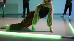 Dancer performing in TL studio with neon lights