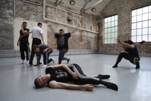 6 male dancers in various positions in the studio space