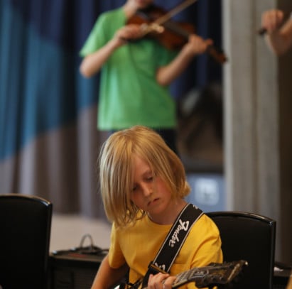 A young musician playing guitar