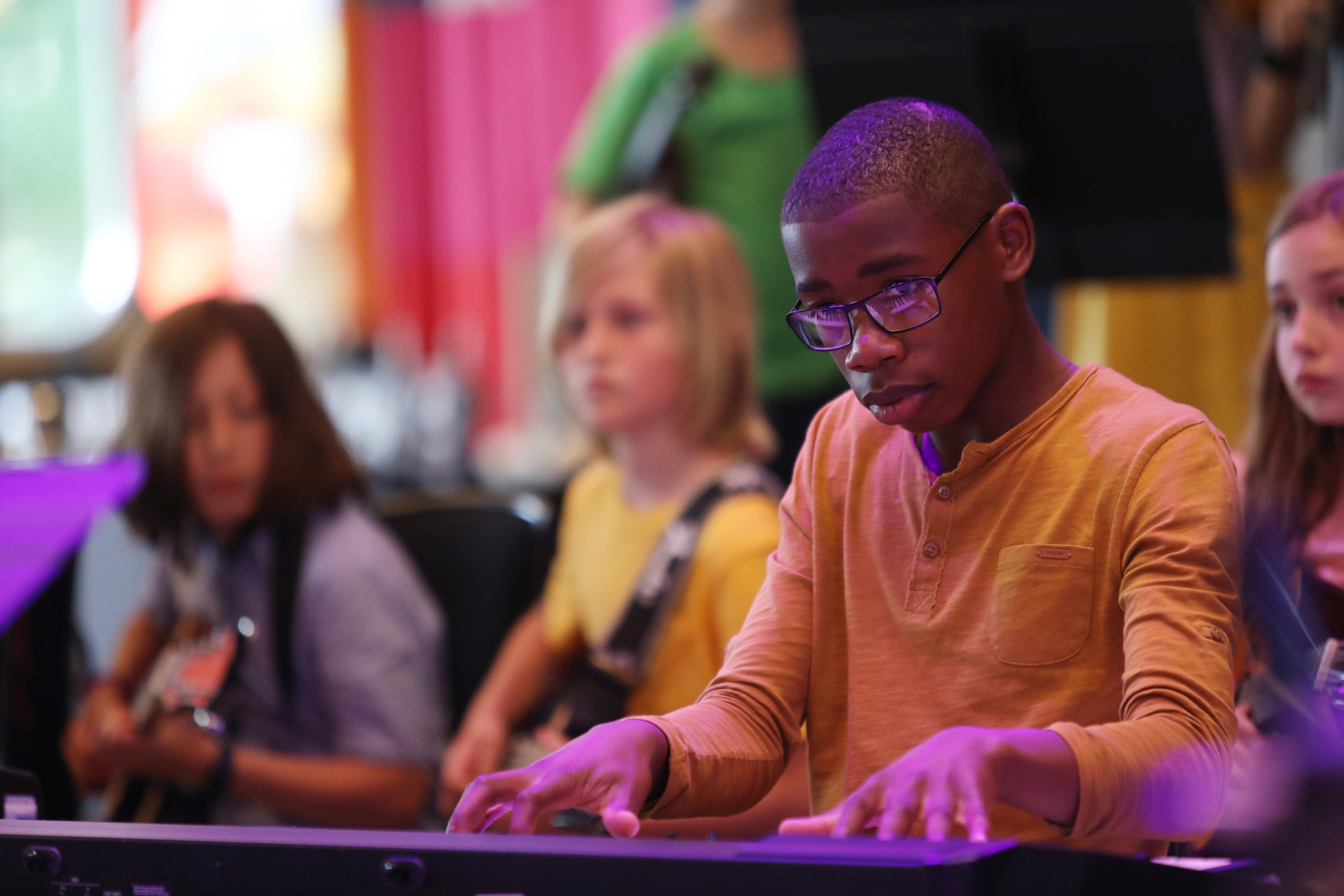 A young person playing the keyboard