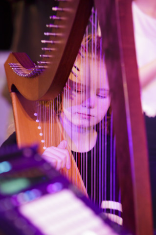 A young musician playing the harp