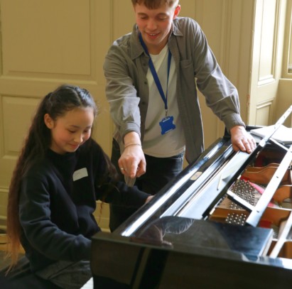 A Trinity Laban Jazz student coaching a young musician