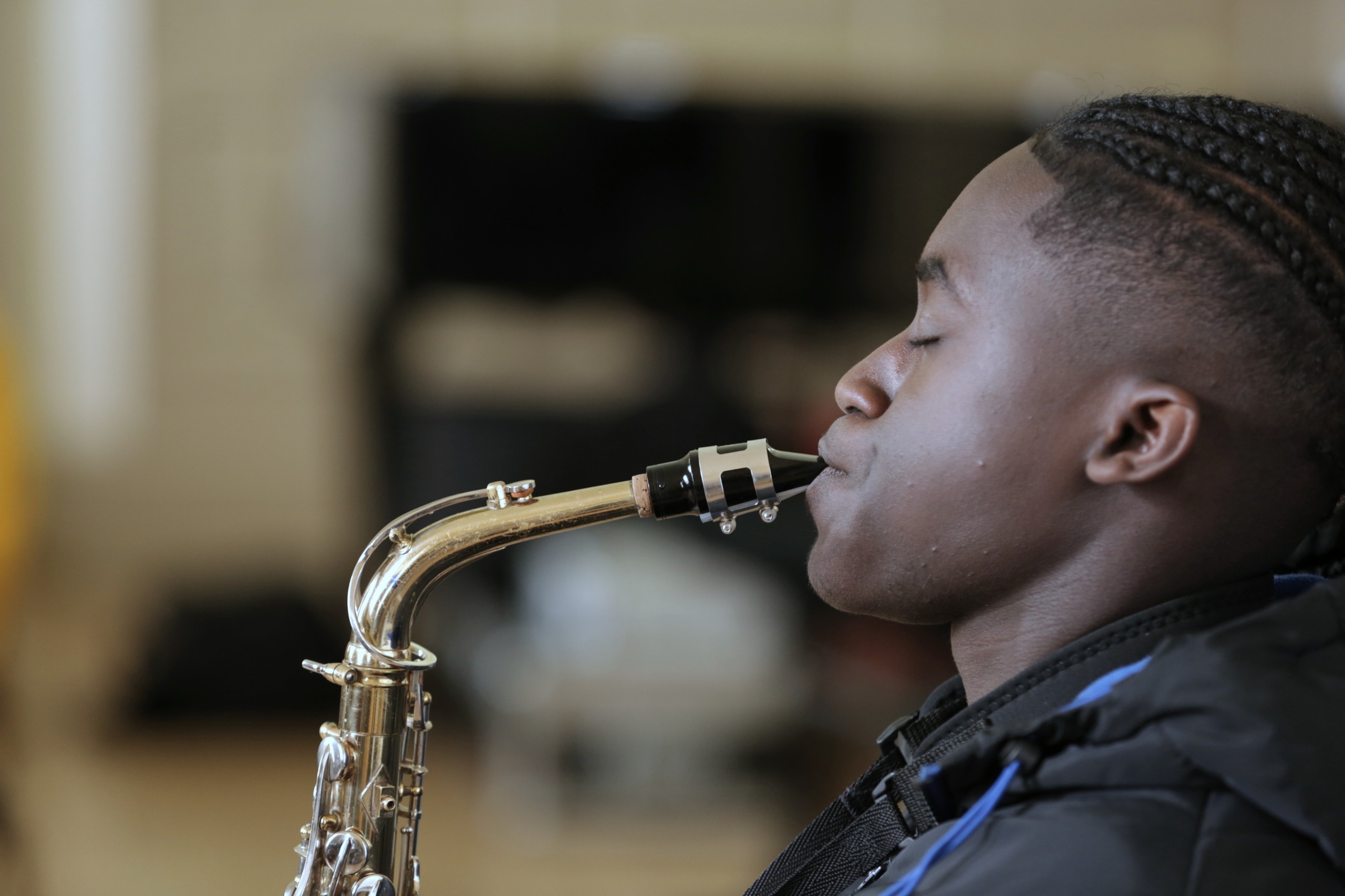 A young musician playing saxophone