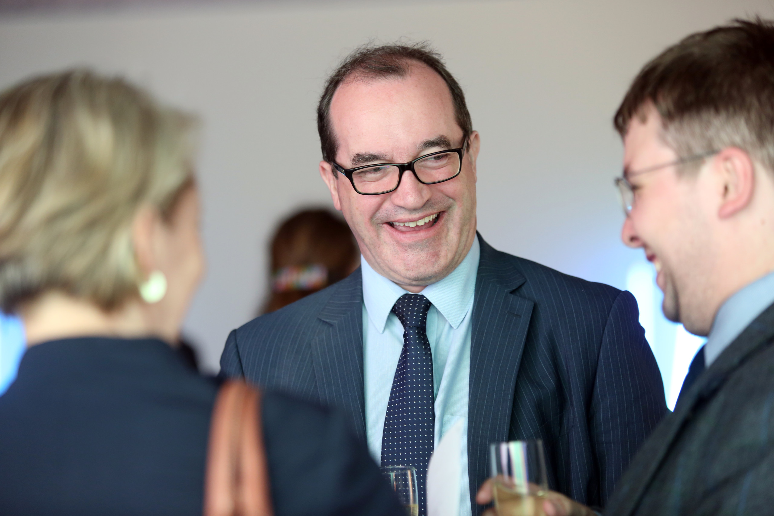 Jonathan Peel at drinks reception smiling at guests