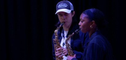 Two saxophone students playing side by side