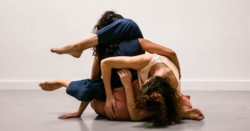 Two dancers on floor in an embrace