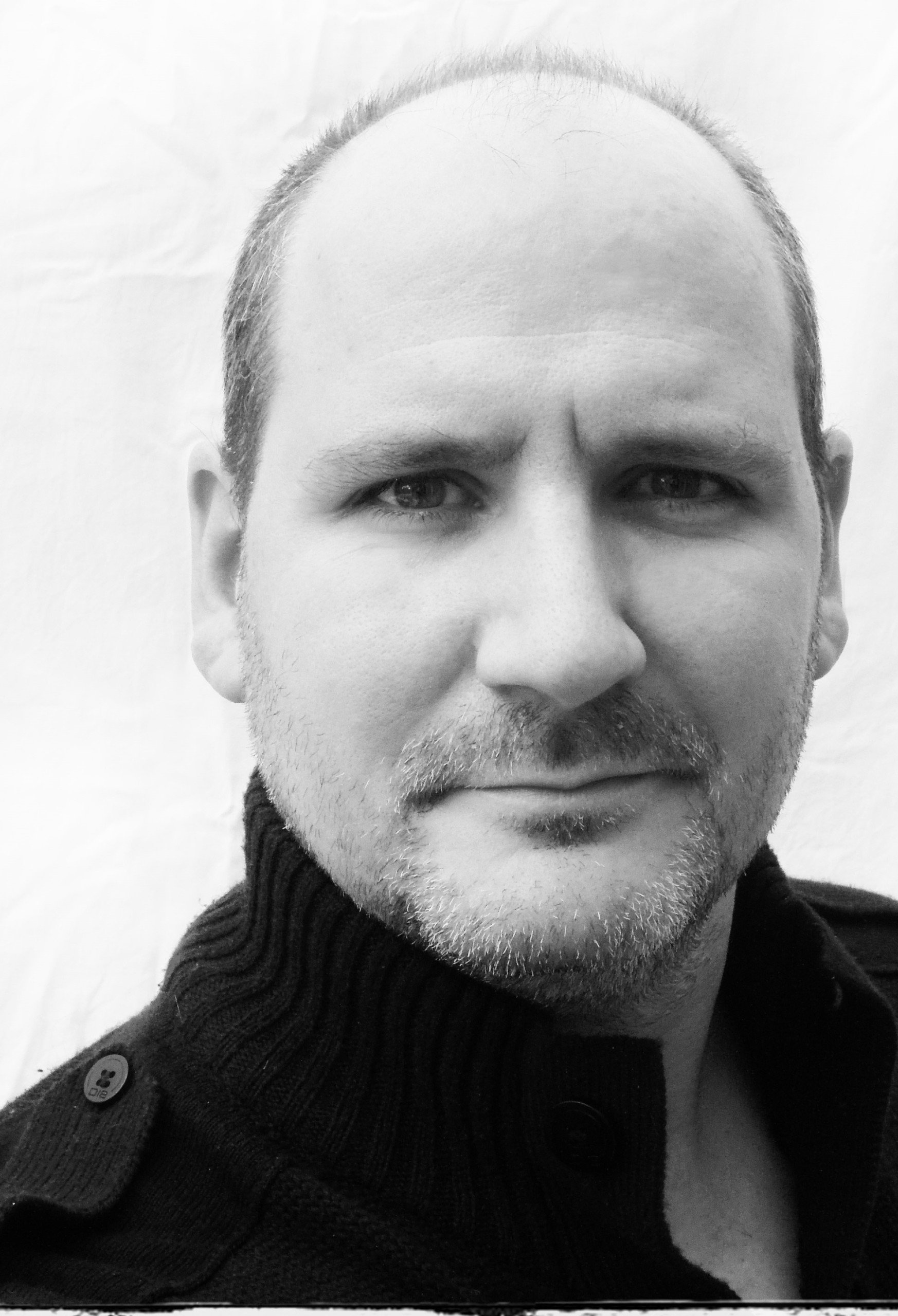 Black and white portrait image of Kasper Cornish facing the camera straight on.