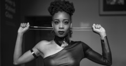Ayanna Witter Johnson holding cello bow behind her head with defiant expression