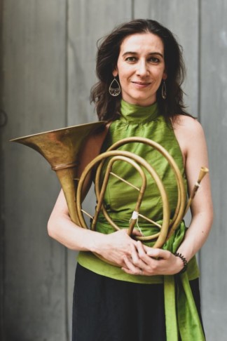 Photo of Anneke Scott holding a horn