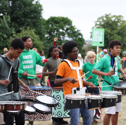 Drummers from South London Samba perform outside in Mountsfield Park