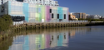 A Picture of the Laban building with the sun creating a rainbow effect on the glass.