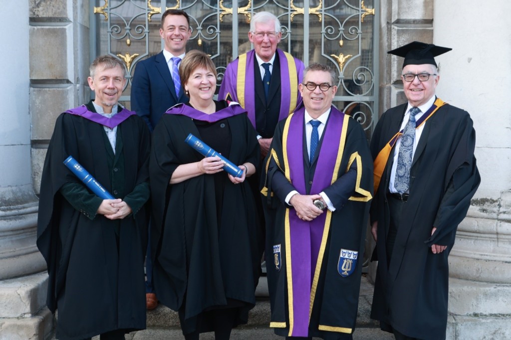 Sam Jackson, Geoffrey Copeland, Gilles Peterson, Sarah Kemp, Professor Anthony Bowne and Havilland Willshire standing outside holding scrolls and wearing graduation robes