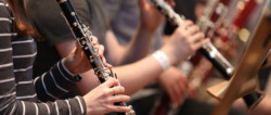 Close up of hands playing a wind instrument